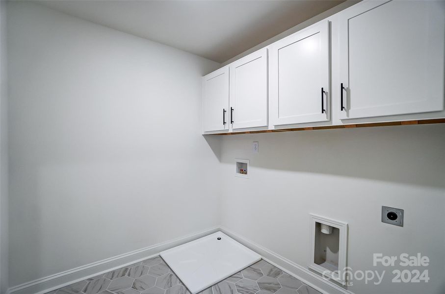 Laundry room with upper cabinets