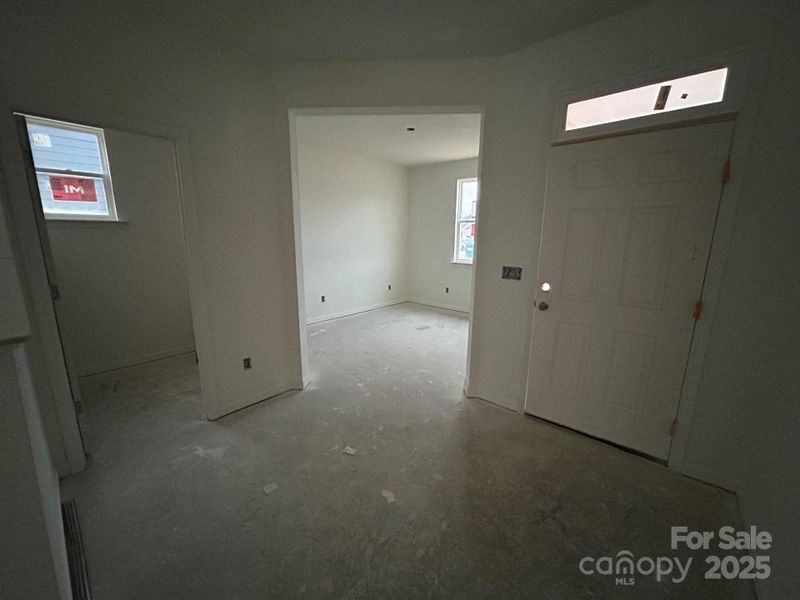 Current stage of foyer. With view of den and powder room. Current stage of foyer. With view of den and powder room.