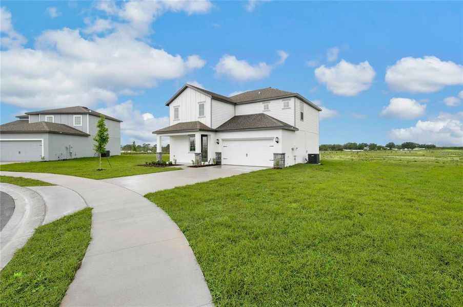 Front exterior of a new home in Citrus Place, Babson Park, FL, highlighting curb appeal (Image 18).