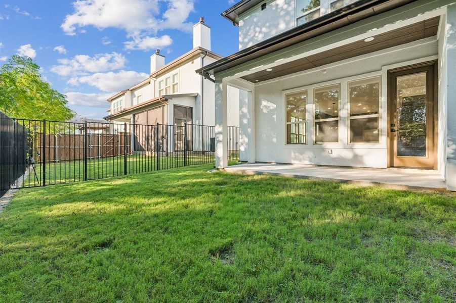 Covered patio with fenced yard.