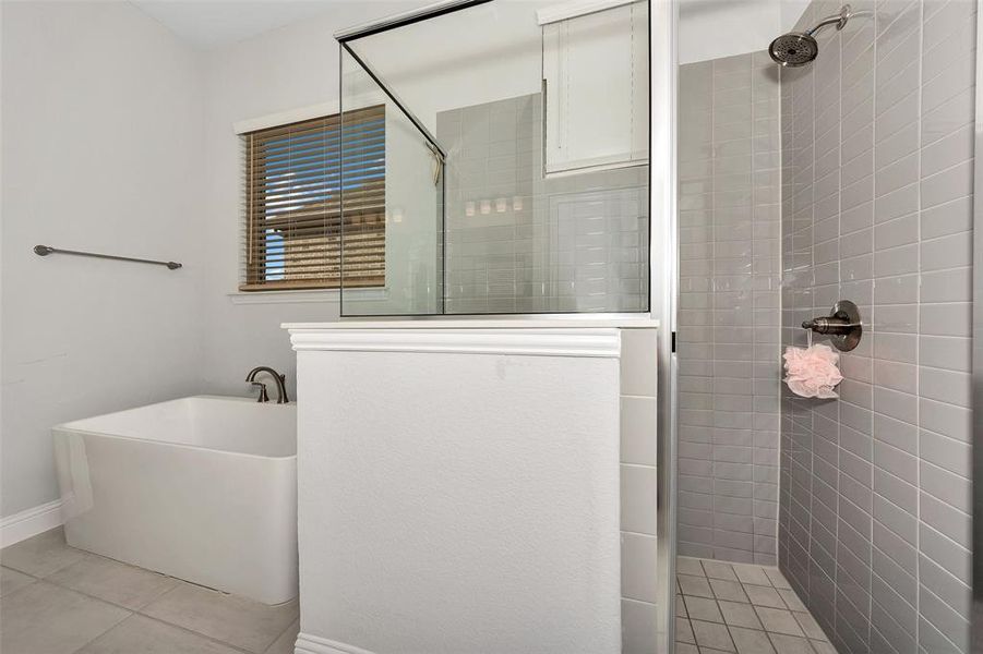 Bathroom featuring separate shower and tub and tile patterned flooring