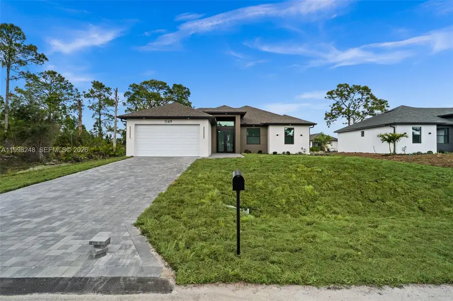 Front exterior of a new home in , Lehigh Acres, FL, highlighting curb appeal (Image 16).