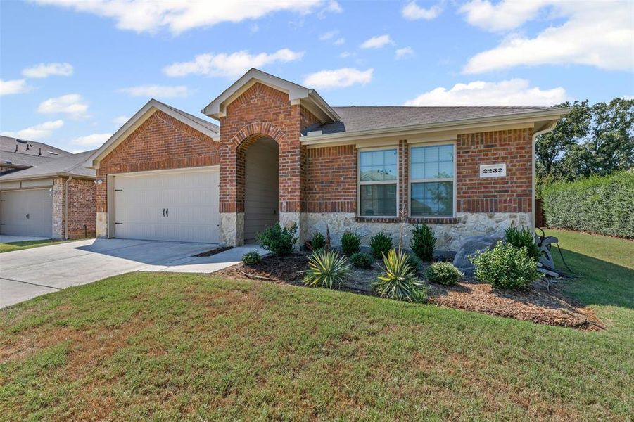 Beautiful brick and stone single-story home with charming curb appeal, manicured landscaping, and a spacious two-car garage in a quiet neighborhood. Beautiful brick and stone single-story home with charming curb appeal, manicured landscaping, and a spacious two-car garage in a quiet neighborhood.