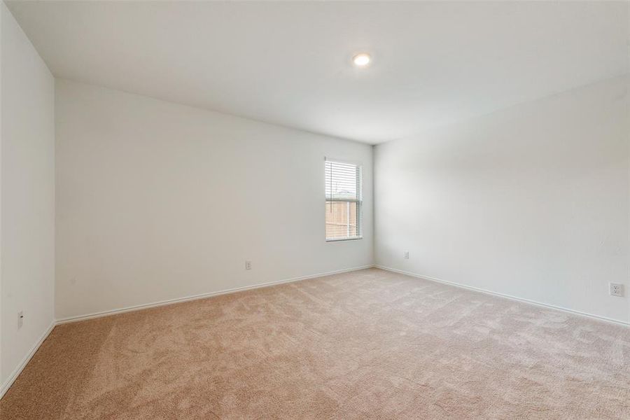 Empty room featuring light carpet