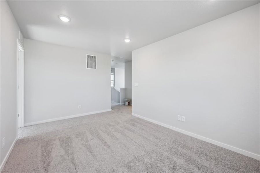 A room with a carpet and a white wall. A room with a carpet and a white wall.