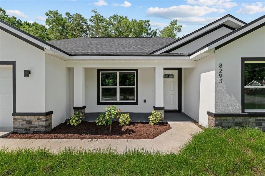 landscaped entryway with epoxy painted porch