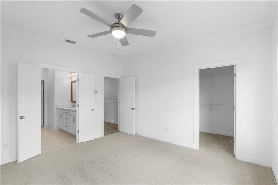 primary bedroom with walk in closet - leads into the bathroom - bathroom has double doors - *Pictures represent a previously built home, not the actual home, home is under construction*
