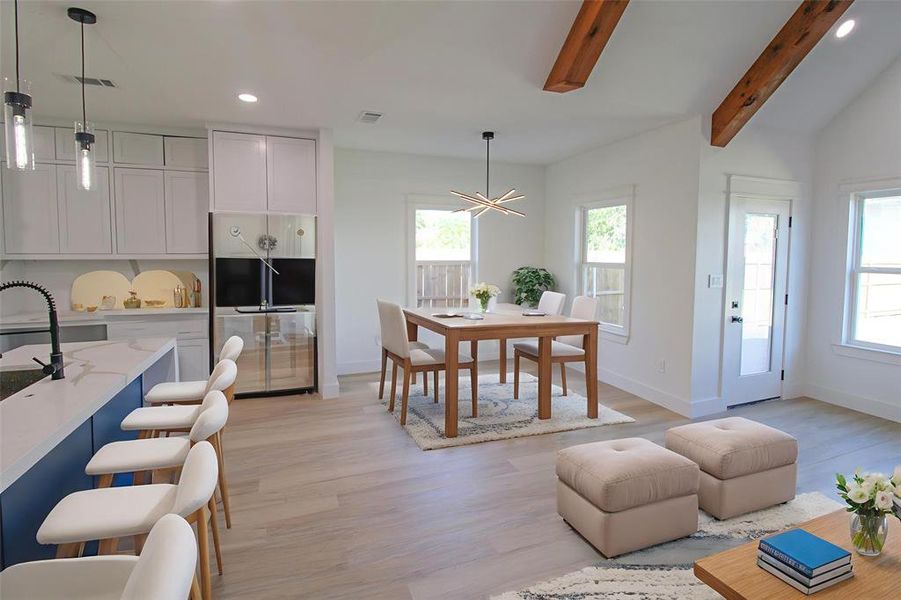 Dining area with recessed lighting, light wood finished floors, and a chandelier Dining area with recessed lighting, light wood finished floors, and a chandelier