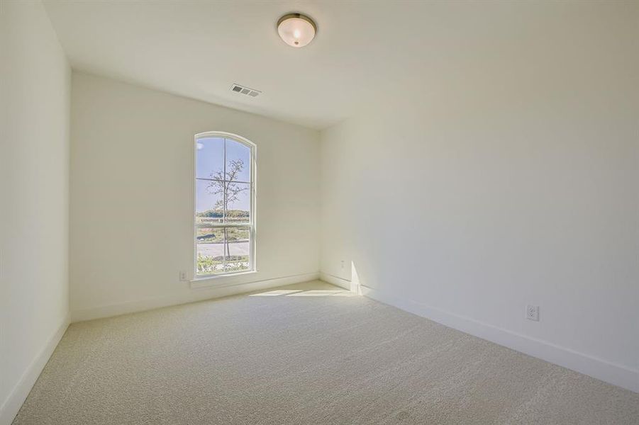 Unfurnished room featuring light colored carpet and baseboards