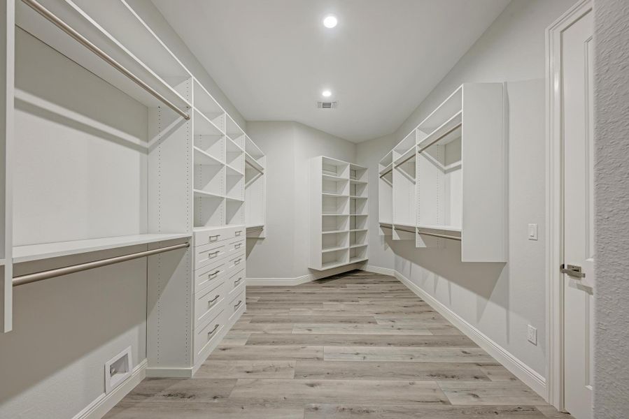 Spacious closet with light wood-style floors