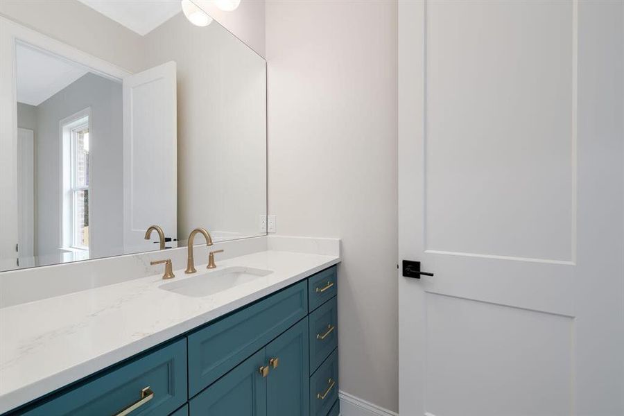 Bathroom featuring vanity and baseboards Bathroom featuring vanity and baseboards