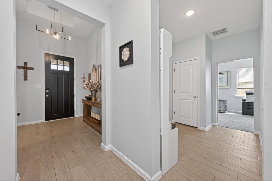 Inviting entryway highlighted by tall ceilings and an open design