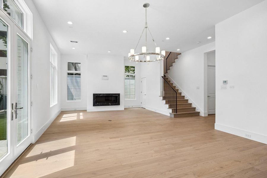 View of the dining space looking into the living room with linear fireplace.