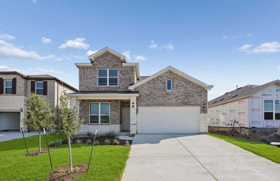 Front exterior of a new home in Lagos, Manor, TX, highlighting curb appeal (Image 21). Front exterior of a new home in Lagos, Manor, TX, highlighting curb appeal (Image 21).