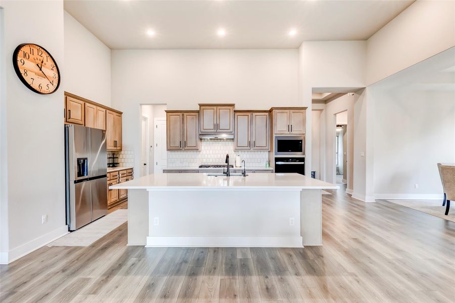 Culinary delights await in this bright kitchen with a spacious island, modern appliances, and seamless open-concept living.
