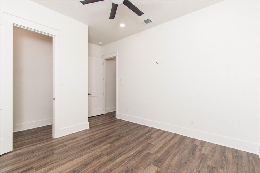 Hardwood-style flooring extends across this spacious bedroom, ready for personalization.
