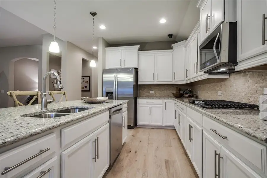 Kitchen featuring a large island ideal for informal dining and gatherings *Model representation Kitchen featuring a large island ideal for informal dining and gatherings *Model representation