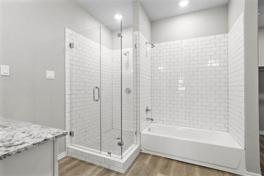 Nice sized shower and separate tub with a classic subway tile look.