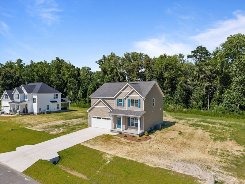 Front exterior of a new home in Laurel Oaks, Greenville, NC, highlighting curb appeal (Image 32). Front exterior of a new home in Laurel Oaks, Greenville, NC, highlighting curb appeal (Image 32).