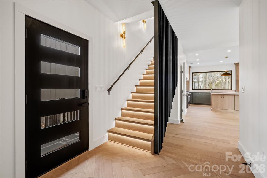 Spacious foyer designed for both form and function with curated lighting