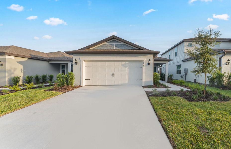 Front exterior of a new home in Twisted Oaks, Wildwood, FL, highlighting curb appeal (Image 2). Front exterior of a new home in Twisted Oaks, Wildwood, FL, highlighting curb appeal (Image 2).