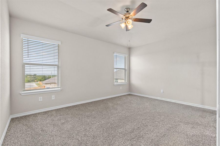 Unfurnished room featuring carpet floors and a ceiling fan