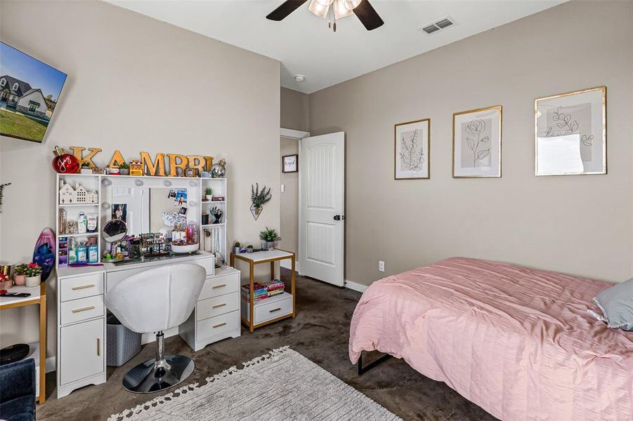 Bedroom featuring ceiling fan and an office area Bedroom featuring ceiling fan and an office area