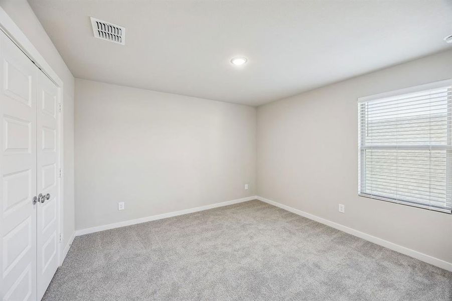 Bedroom in the Willow home plan by Trophy Signature Homes – REPRESENTATIVE PHOTO