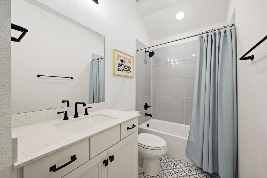 The secondary bathroom is beautifully appointed with decorative tile flooring, a Quartz countertop, and a tub shower combination finished with a classic subway tile surround for a clean, upscale look. The secondary bathroom is beautifully appointed with decorative tile flooring, a Quartz countertop, and a tub shower combination finished with a classic subway tile surround for a clean, upscale look.