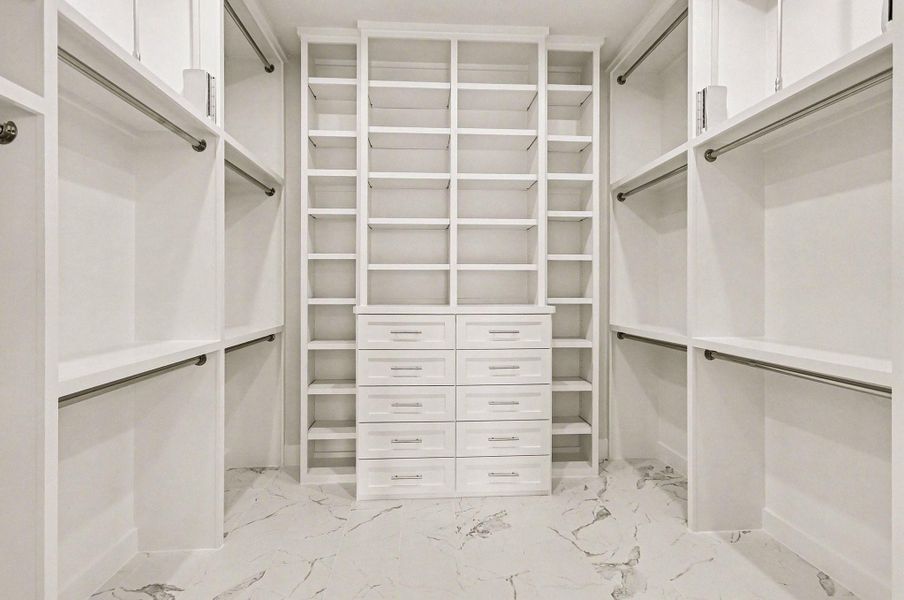 Custom walk-in closet with built-ins, drawers, and exceptional storage solutions.