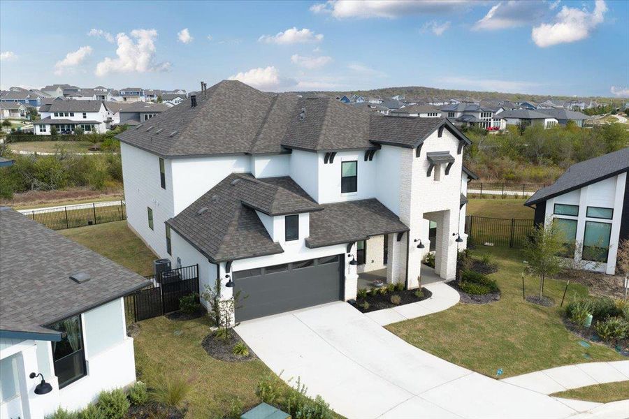 View of front of home featuring a shingled roof, stucco siding, driveway, and a residential view View of front of home featuring a shingled roof, stucco siding, driveway, and a residential view
