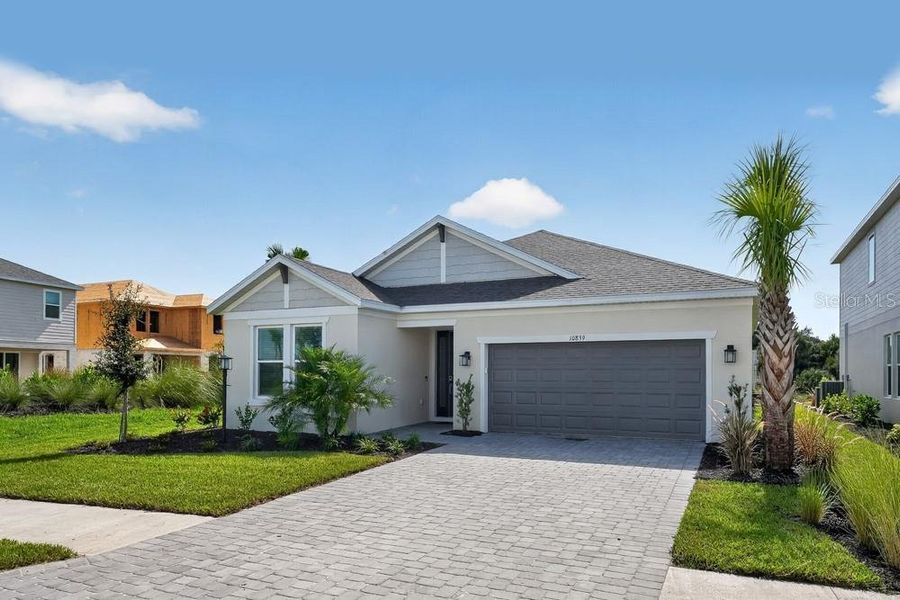Front exterior of a new home in Skye Ranch Community Group Page, Sarasota, FL, highlighting curb appeal (Image 16). Front exterior of a new home in Skye Ranch Community Group Page, Sarasota, FL, highlighting curb appeal (Image 16).