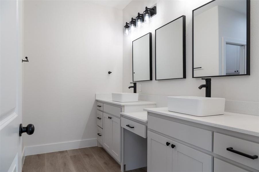 Bathroom featuring vanity and hardwood / wood-style floors