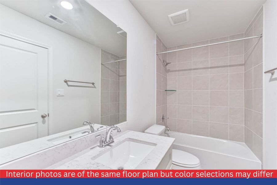 This charming bathroom offers a perfect blend of style and functionality. From the chic vanity to the modern fixtures, it presents a space that effortlessly combines convenience and aesthetic appeal.