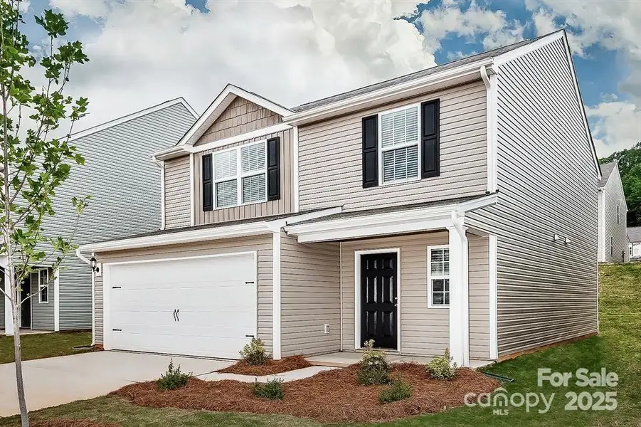 Front exterior of a new home in McKee Creek Village, Charlotte, NC, highlighting curb appeal (Image 1).