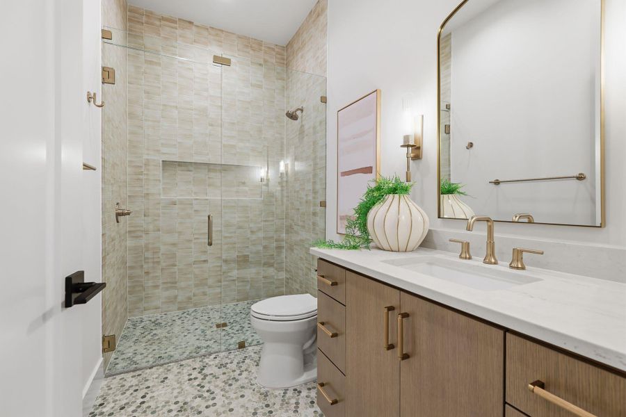 Full bath with vanity, a walk-in shower, and light tile patterned floors