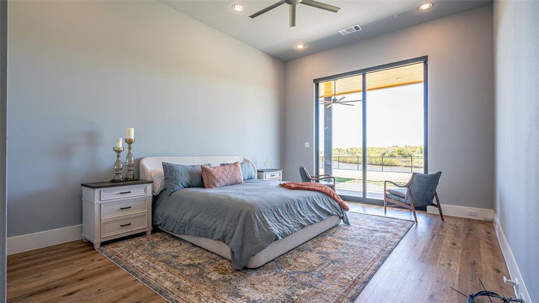 Bedroom featuring hardwood / wood-style floors, access to outside, and ceiling fan