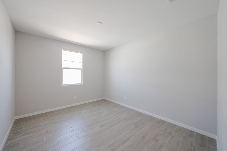 A room with a wood floor and a window.