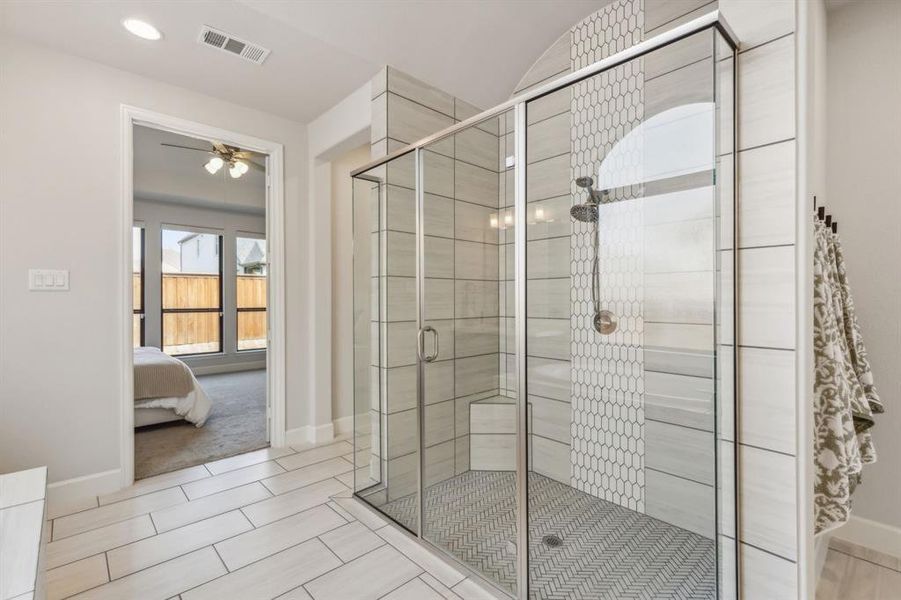 Bathroom with a shower with door and ceiling fan