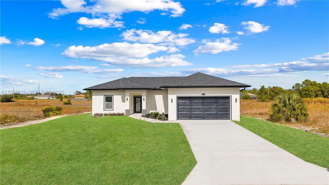 Front exterior of a new home in , Lehigh Acres, FL, highlighting curb appeal (Image 17).