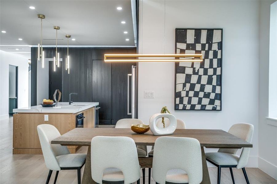 Dining room with sink and light hardwood / wood-style floors