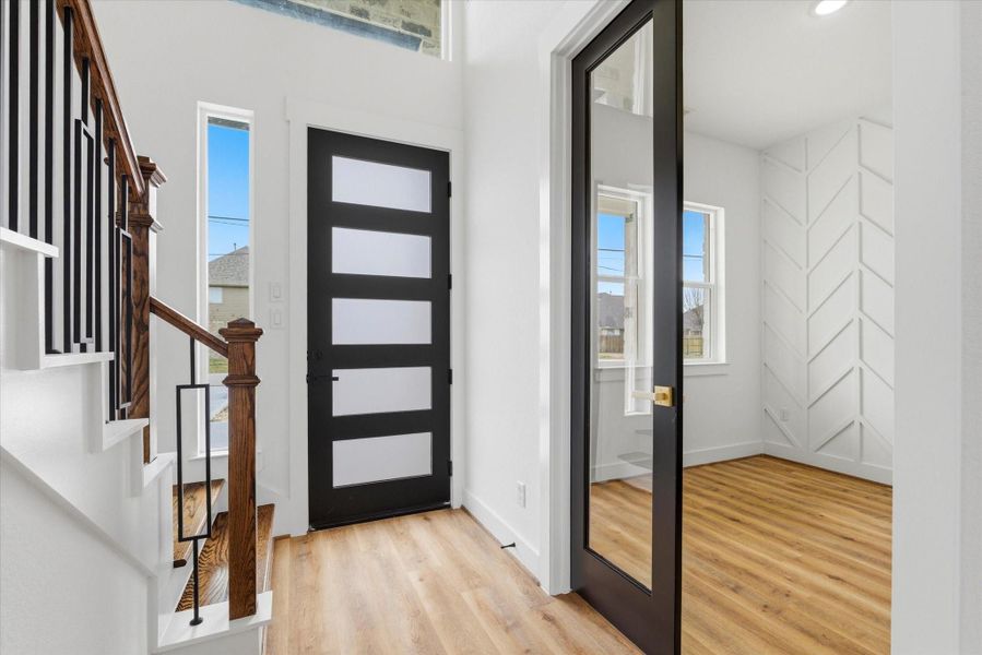 Step inside and be welcomed by a grand foyer with soaring 21-foot ceilings.