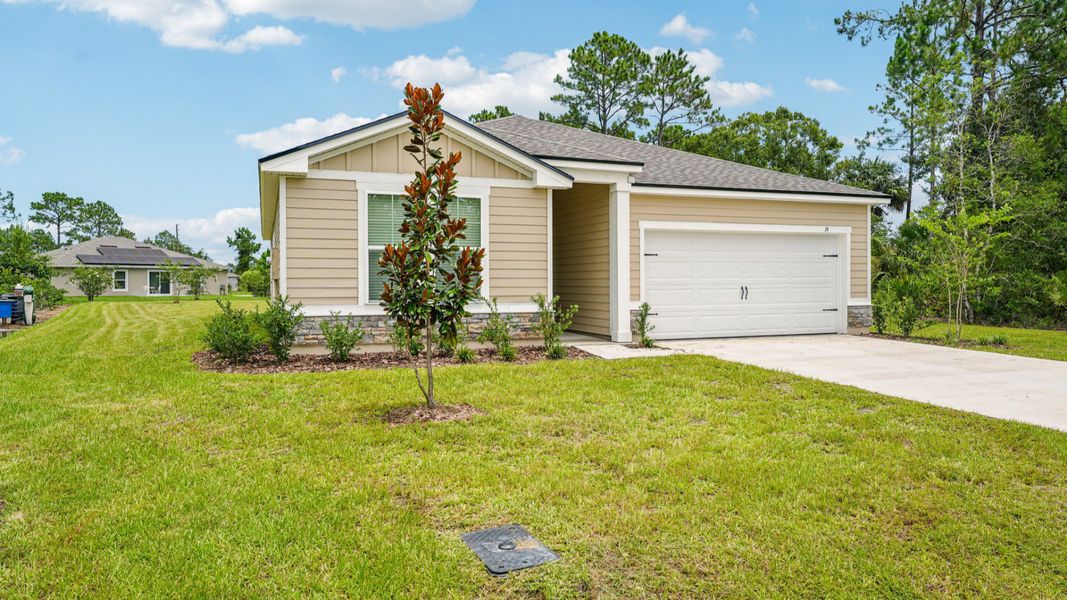Front exterior of a new home in Palm Coast, Palm Coast, FL, highlighting curb appeal (Image 21).