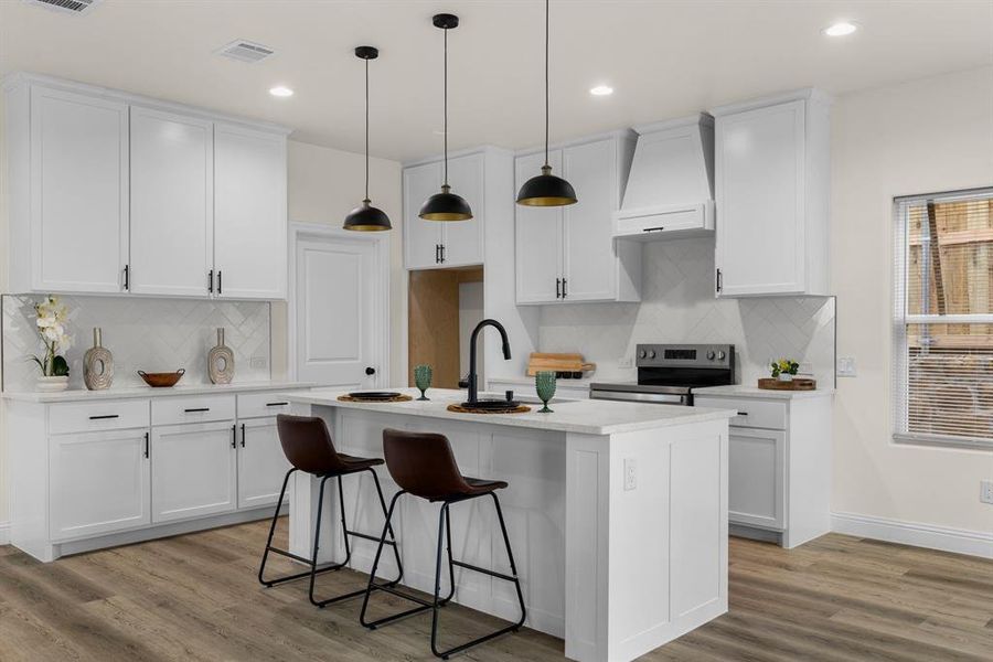 Kitchen featuring pendant lighting, white cabinetry, stainless steel electric range, and custom range hood