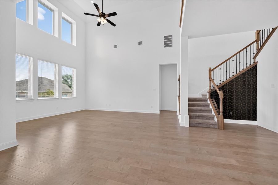 Towering ceilings and wood-look flooring establish an airy, modern feel in this central gathering space. Towering ceilings and wood-look flooring establish an airy, modern feel in this central gathering space.