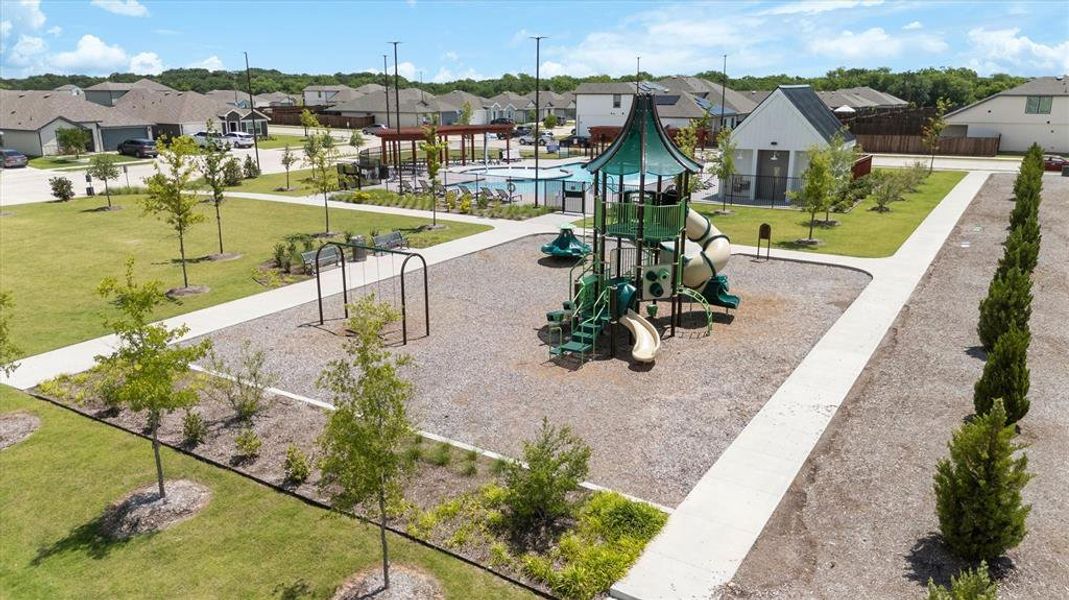 Outdoor playground featuring a multi-level play structure with slides and swings
