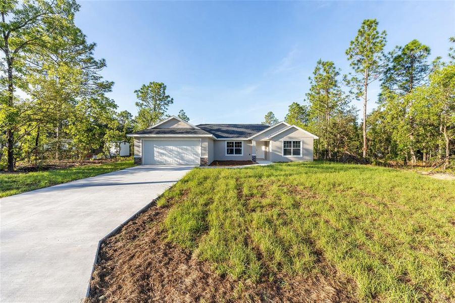 Front exterior of a new home in , Dunnellon, FL, highlighting curb appeal (Image 2).