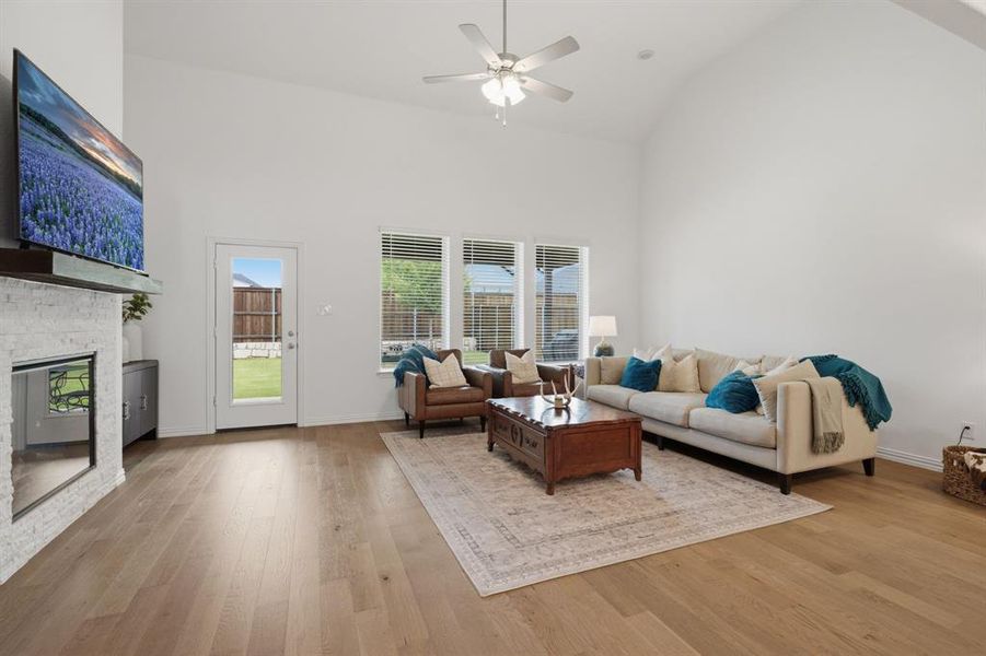 Soaring ceilings, a cozy fireplace, and walls of windows make this living room feel bright, spacious, and inviting. The open layout at 905 Bluebell St in Princeton, TX gives buyers the better-than-new home feel they want without the wait.