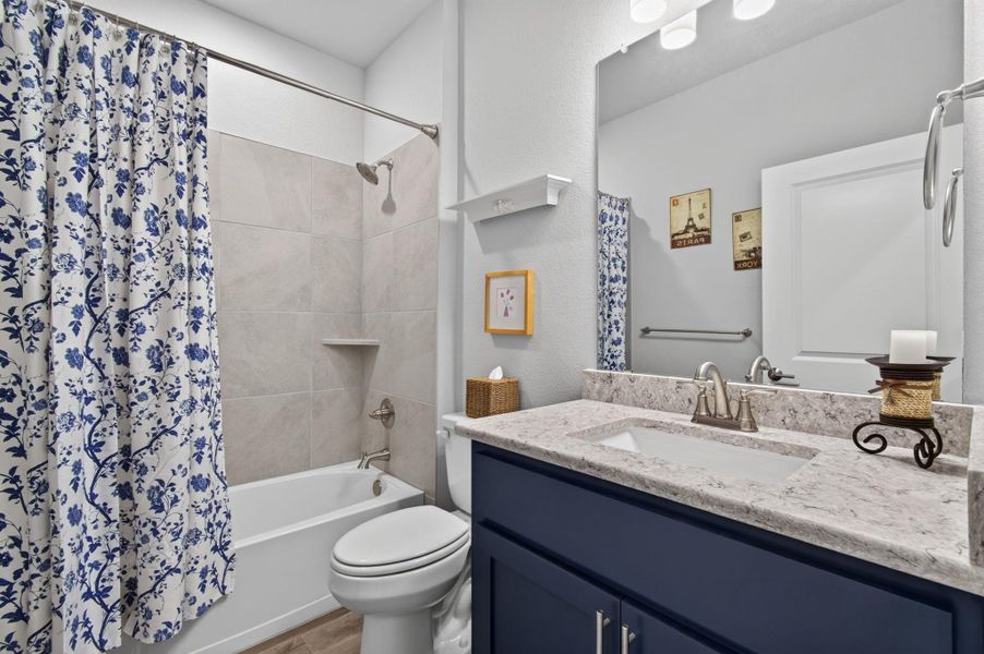 A pristine bathroom featuring a deep soaking tub, a sleek vanity, and elegantly tiled shower walls. A pristine bathroom featuring a deep soaking tub, a sleek vanity, and elegantly tiled shower walls.