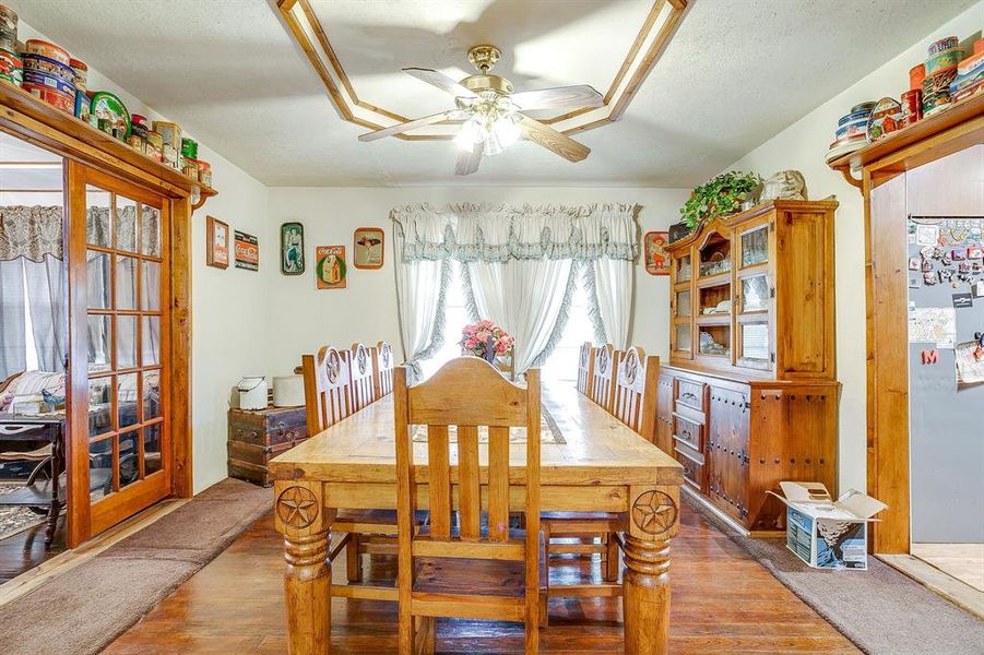 Dining space with wood-type flooring and a ceiling fan Dining space with wood-type flooring and a ceiling fan